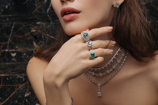 A woman with emerald rings